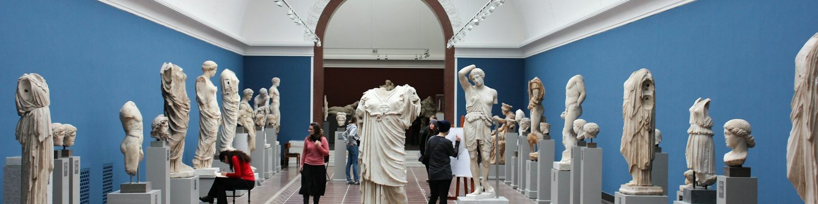 people watching statue in gallery room